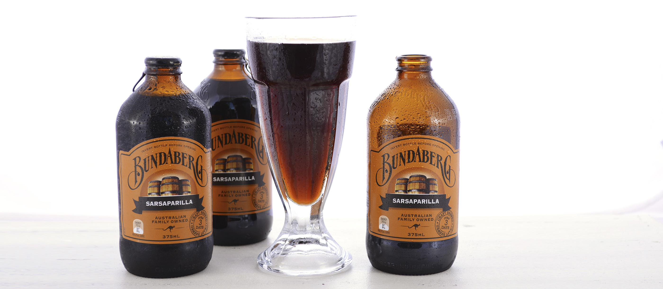 Bundaberg Sarsaparilla bottles and a glass of the drink